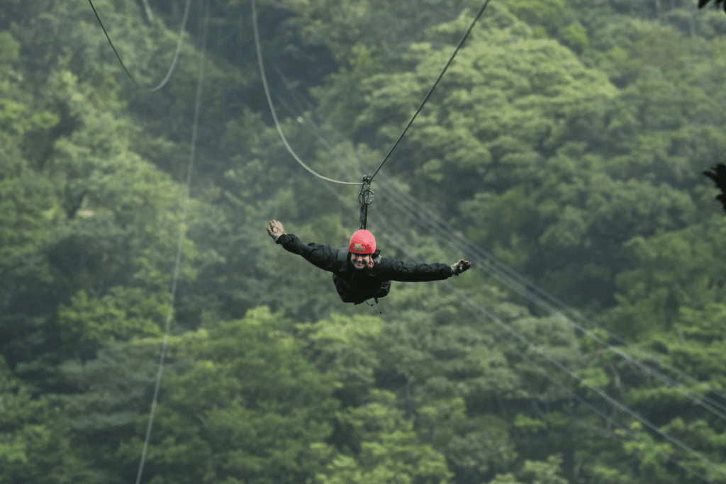 superman flying on a zipline in monteverde costa rica. 