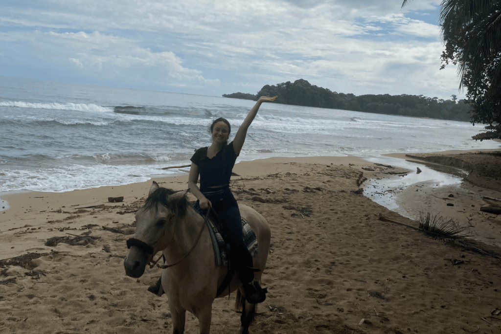 girl riding a horse on a beach in Puerto Viejo.